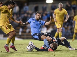 Joe Gauci of Adelaide United dives at the feet of Kosta Barbarouses of Sydney FC