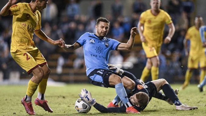 Joe Gauci of Adelaide United dives at the feet of Kosta Barbarouses of Sydney FC
