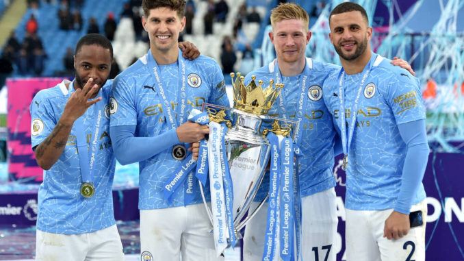 Raheem Sterling-John Stones-Kevin De Bruyne-Kyle Walker pose with the Premier League trophy at the Etihad Stadium