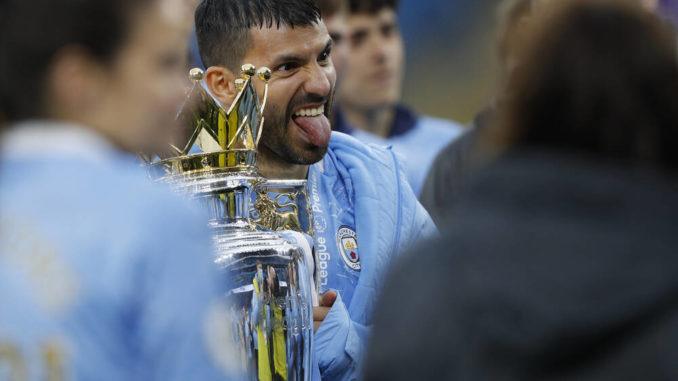 Sergio Aguero of Manchester City holds the Premier League trophy