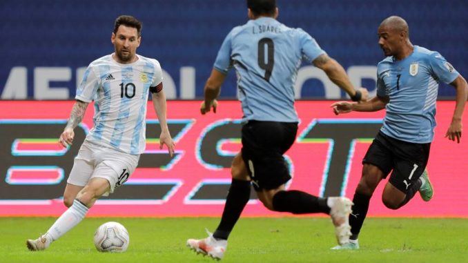 Argentina's Lionel Messi against Uruguay’s Luis Suarez and Nicolas De La Cruz