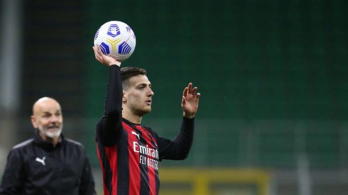 Diogo Dalot and Stefano Pioli of AC Milan