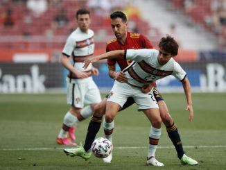 Joao Felix of Portugal and Sergio Busquets of Spain