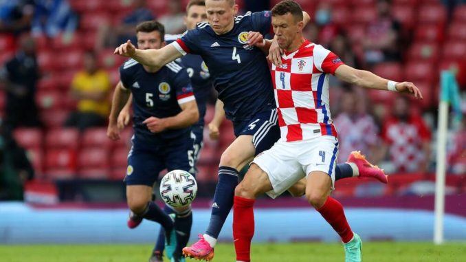 Scott McTominay of Scotland and Ivan Perisic of Croatia