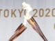 Olympic flame torches kiss during a Tokyo 2020 Olympic Torch Relay event