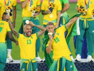 Captain Dani Alves and Richardlison of Brazil celebrate with gold medals in Olympic Football