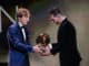 Lionel Messi of Barcelona receiving Ballon d Or 2019 trophy from Luka Modric of Real Madrid