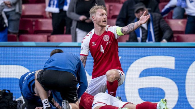 Simon Kjaer and Denmark medical staff attending Christian Eriksen during Euro 2020 match against Finland