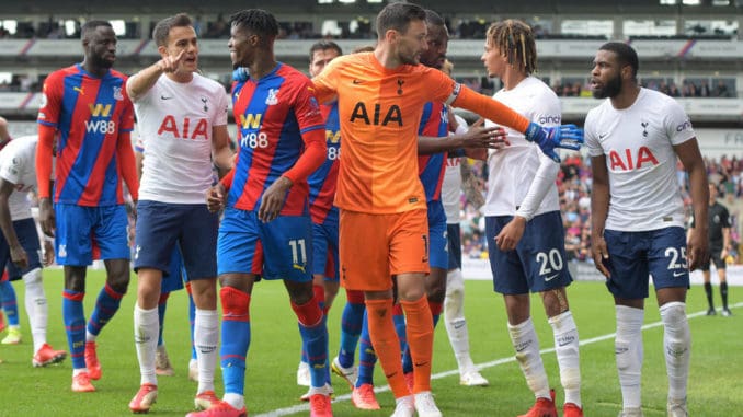 Hugo Lloris of Tottenham Hotspur intervenes with Wilfried Zaha of Crystal Palace during the Premier League match