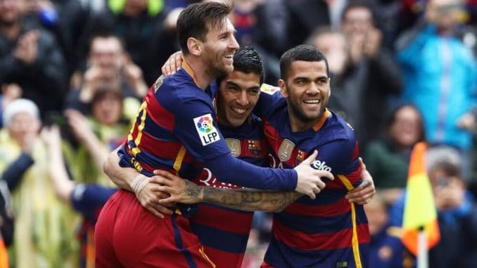 Luis Suarez celebrates his goal with Leo Messi and Daniel Alves of Barcelona