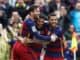 Luis Suarez celebrates his goal with Leo Messi and Daniel Alves of Barcelona
