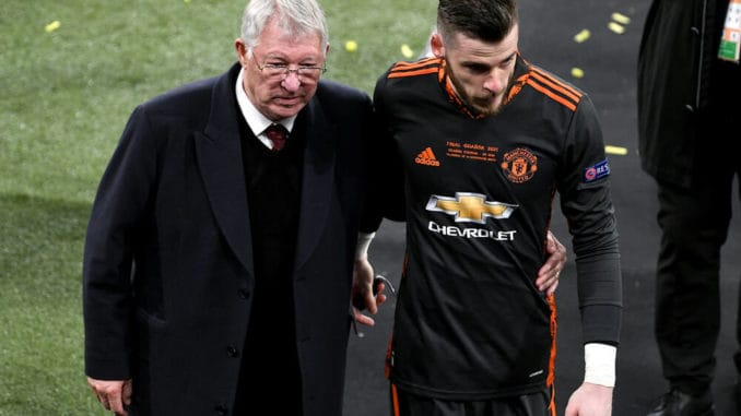 Manchester United goalkeeper David de Gea is consoled by former Manchester United manager Sir Alex Ferguson