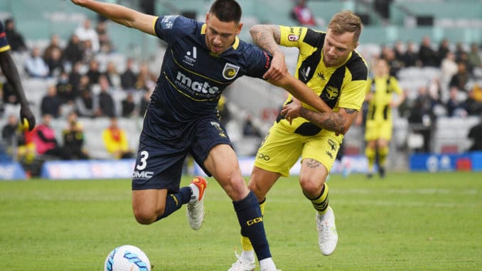 Lewis Miller of the Central Coast Mariners and David Ball of the Wellington Phoenix compete for the ball
