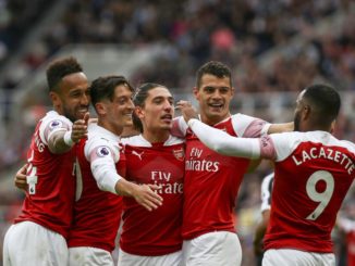 Mesut Ozil of Arsenal is hugged by Hector Bellerín, Pierre-Emerick Aubameyang, Granit Xhaka with Alexandre Lacazette of Arsenal