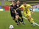 Kai Trewin of Brisbane Roar competes for the ball with David Ball of Wellington Phoenix