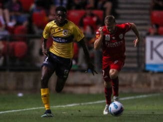 Beni Nkololo of the Central Coast Mariners breaks away from Ryan Kitto of Adelaide United